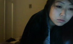 Young Asian brunette FredFreeload lies in bed to participat