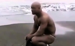 Asian bodybuilder barely covered at the beach