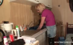Mature housekeeper teasing her hot snatch in the kitchen
